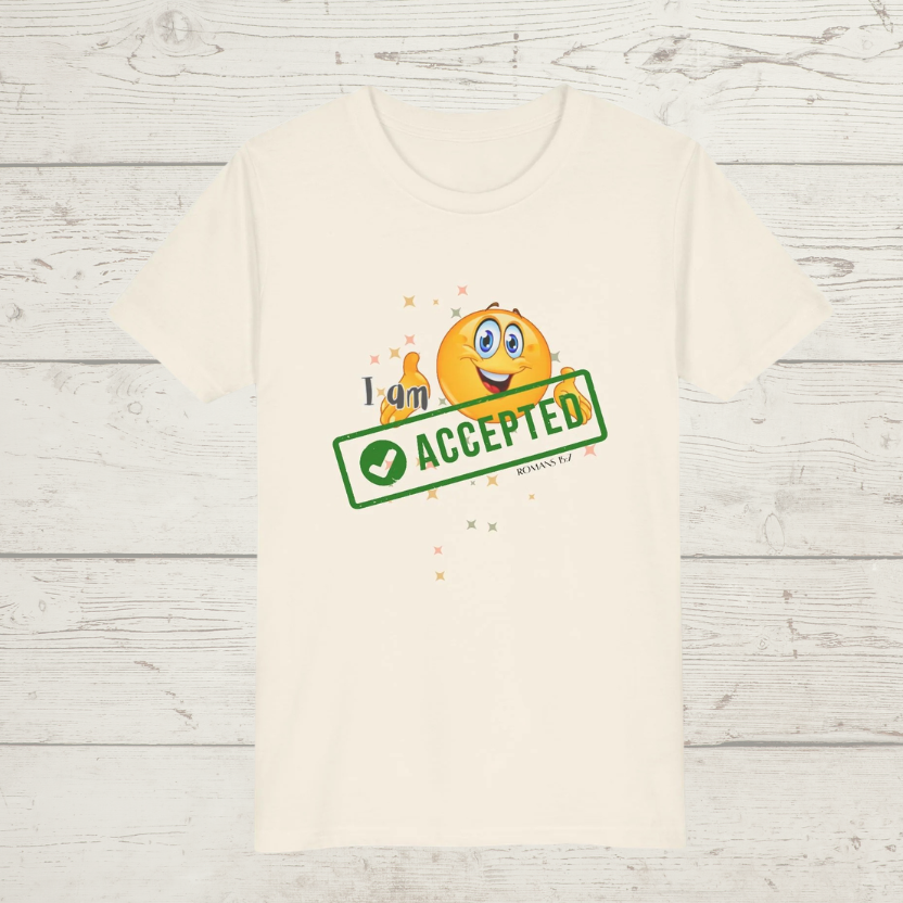 Natural colored t-shirt with a smiley face and 'I am accepted' text on a wooden surface
