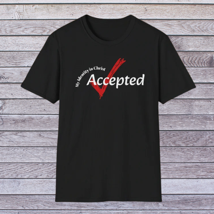 Black t-shirt with a red and white graphic and text on a wooden surface