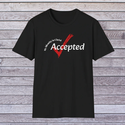 Black t-shirt with a red and white graphic and text on a wooden surface