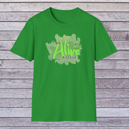 Green t-shirt with 'I am Alive in Christ' design on a wooden background