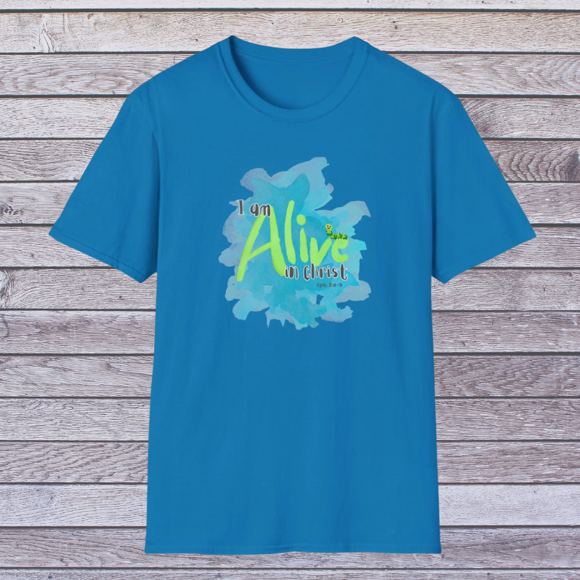 Blue t-shirt with 'I am Alive in Christ' design on a wooden background