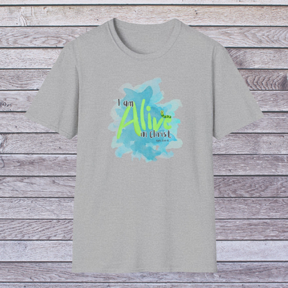 Gray t-shirt with 'I am Alive in Christ' design on a wooden background
