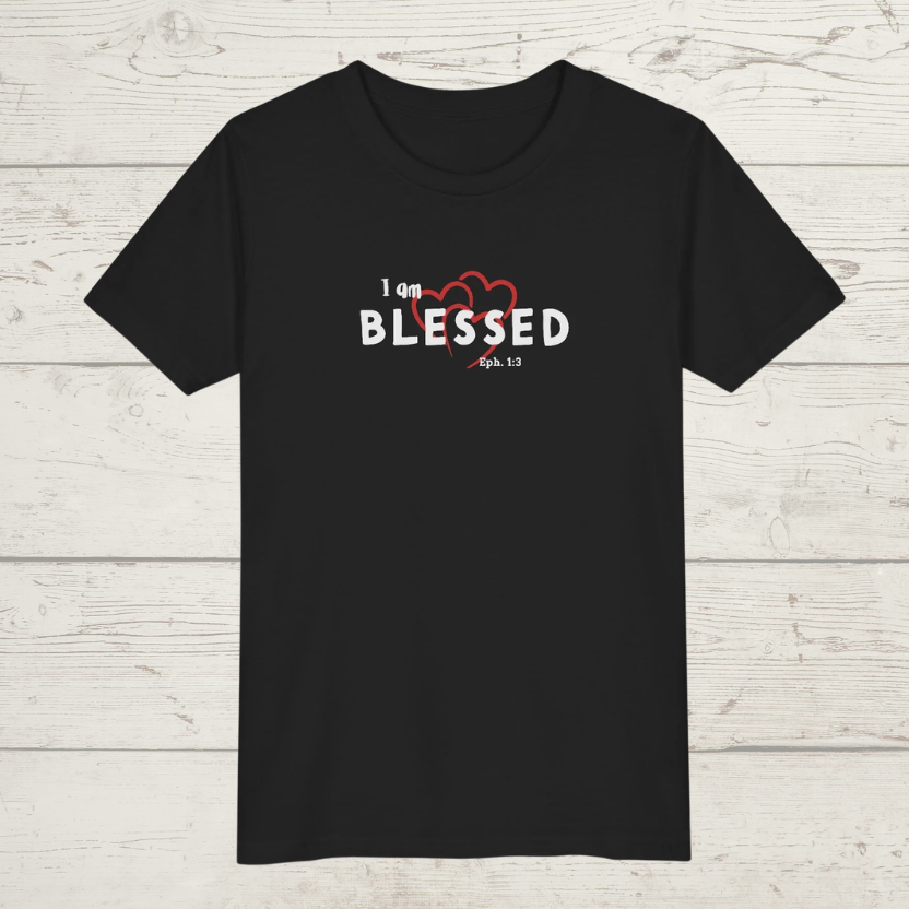 Black t-shirt with 'I am BLESSED' text on a wooden surface