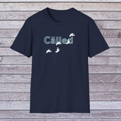 Navy blue t-shirt with 'I am Called' text and footprints on a wooden background