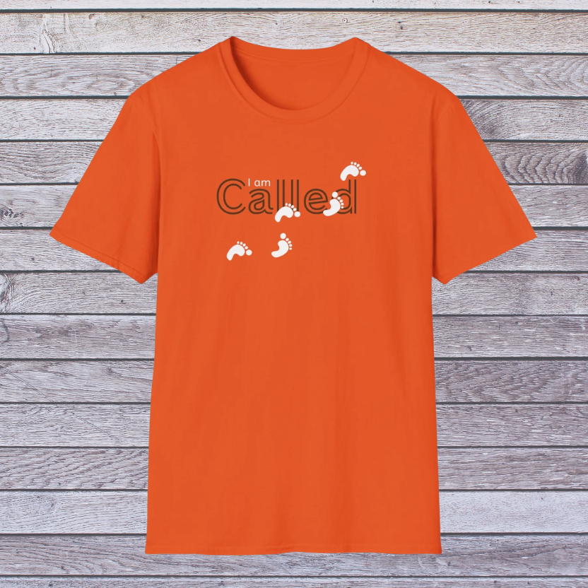 Orange t-shirt with 'I am called' text on a wooden background