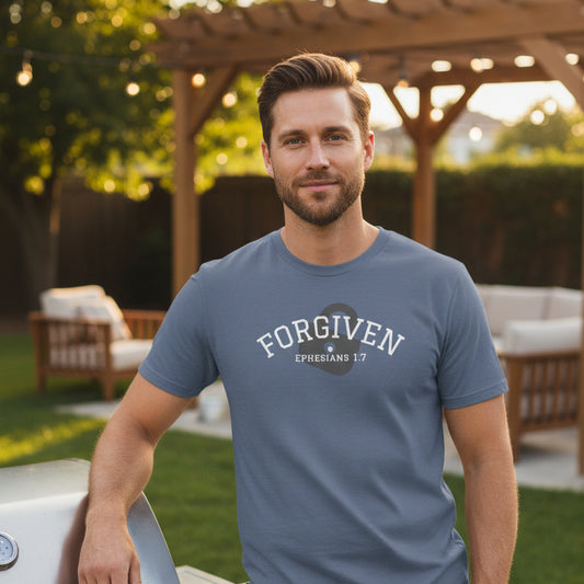 Blue t-shirt with 'forgiven, Ephesians 1:7' text and unlocked lock symbol outside by BBQ