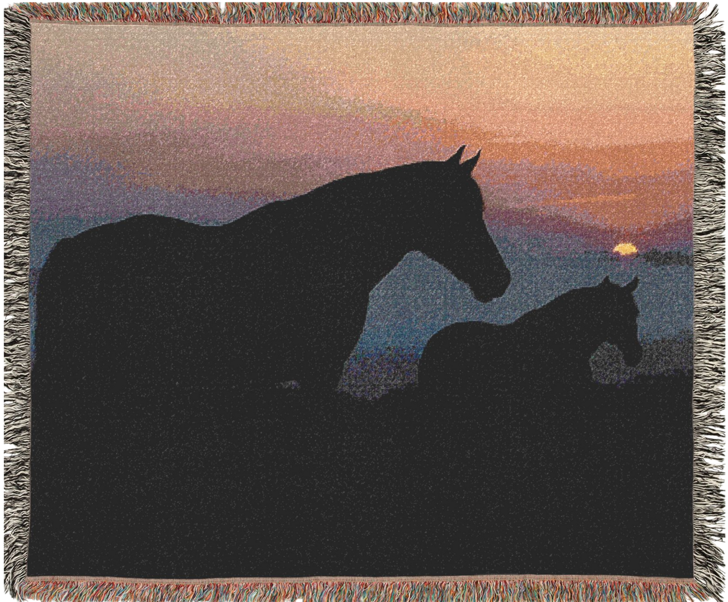 Woven blanket with silhouette of two horses at sunset