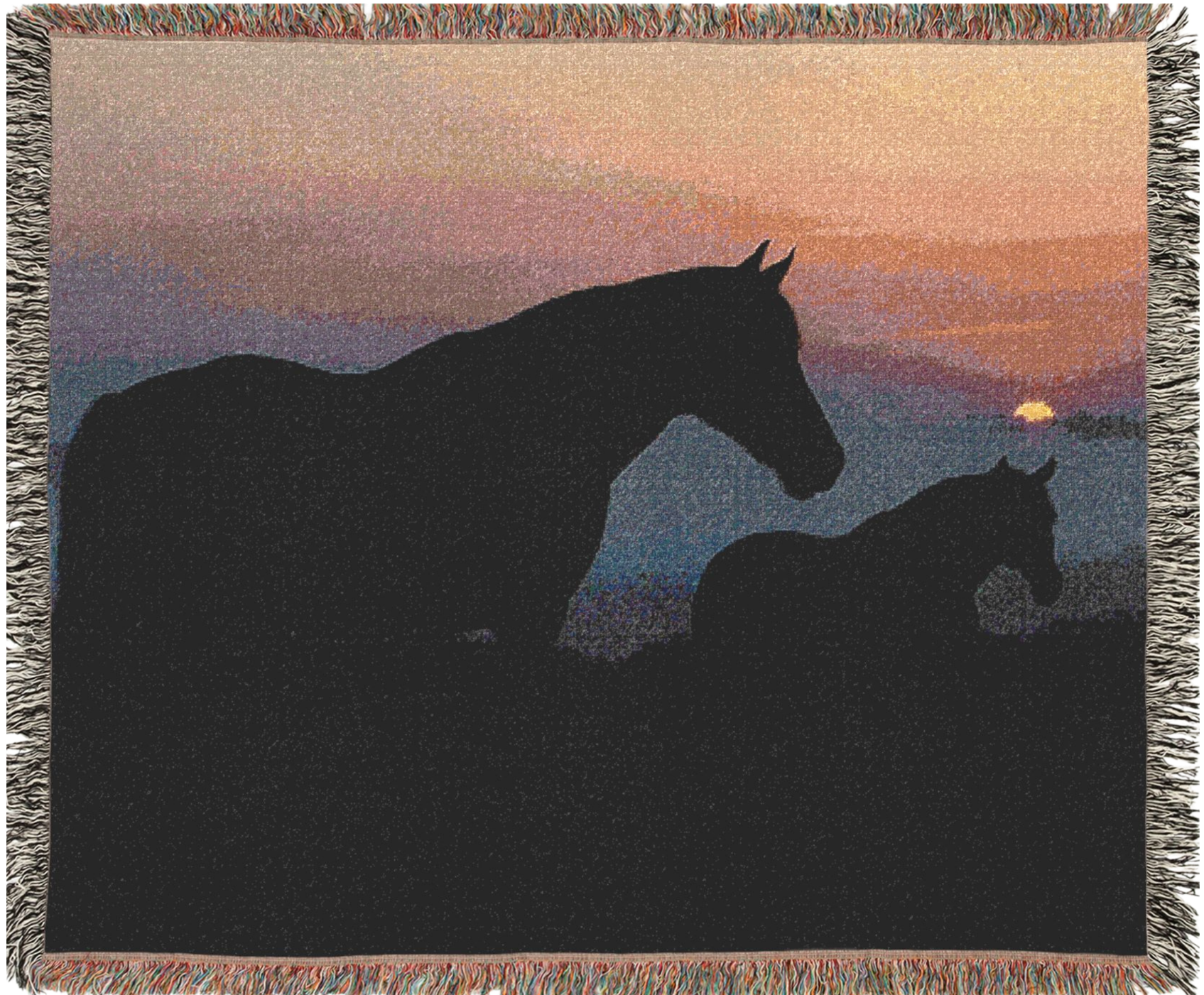 Woven blanket with silhouette of two horses at sunset