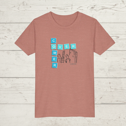 Heather Mauve t-shirt with a graphic design 'Overcomer, 1 John 5:4' on a wooden surface, cartoon image and scrabble tiles
