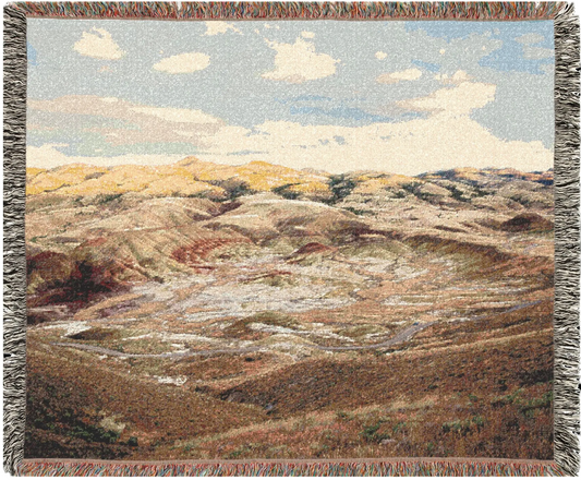 Painted Hills Oregon woven blanket with a landscape design of hills and sky.