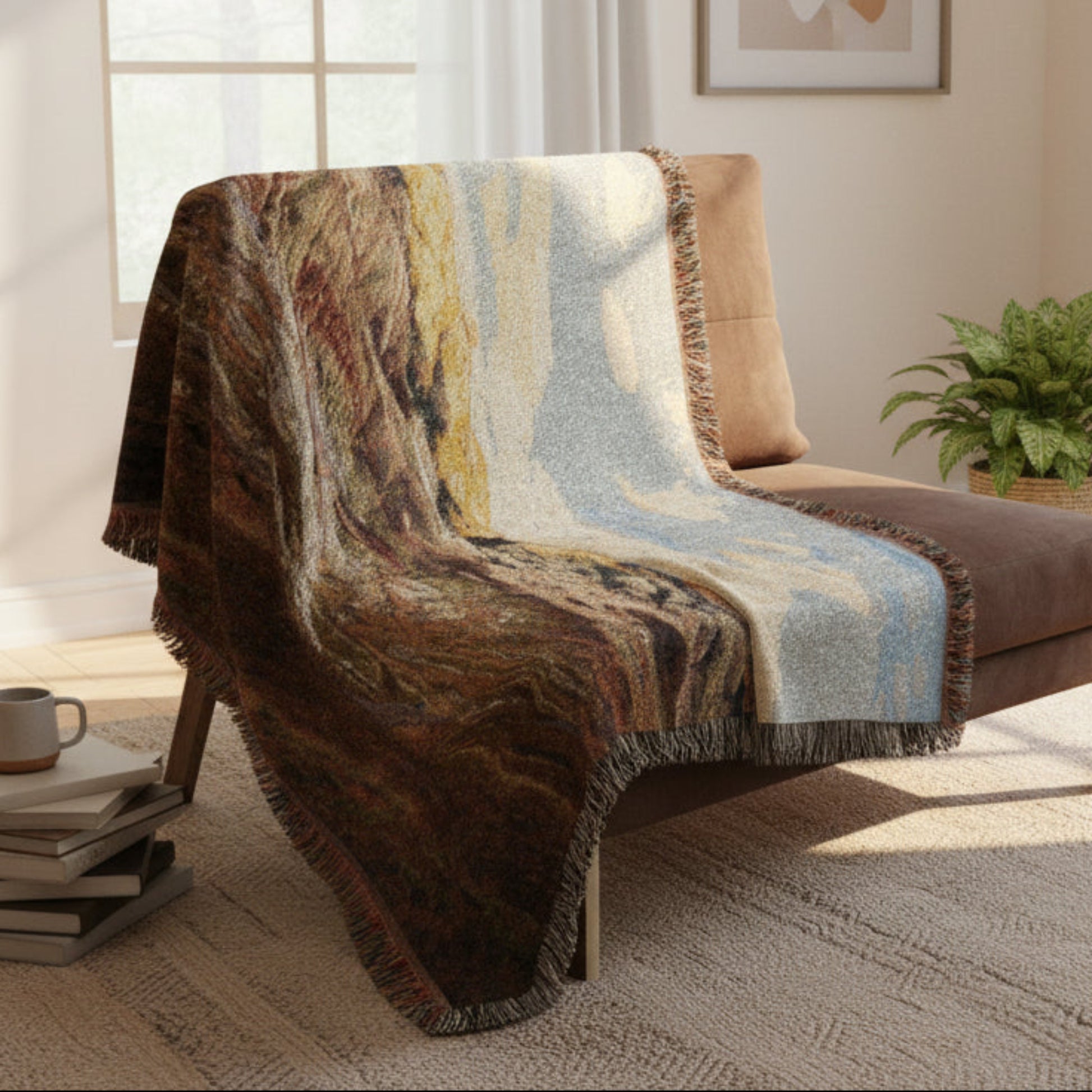 Painted Hill Oregon woven blanket draped over a brown chair in a sunny room