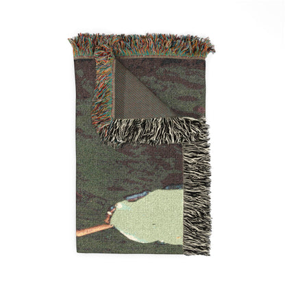 Pink Water Lily woven blanket with fringed edges, folded