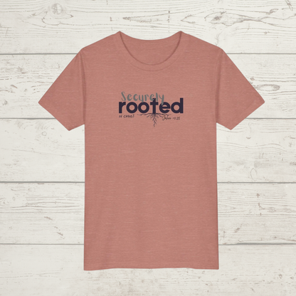 Mauve Pink t-shirt with white text 'Securely Rooted' on a wood background