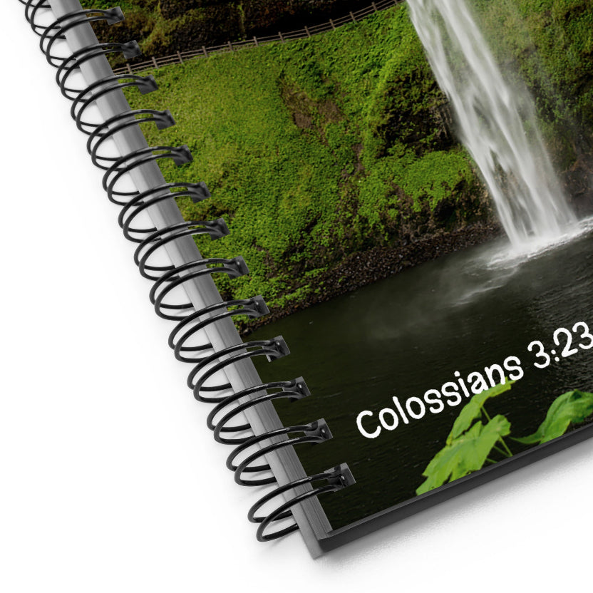 Notebook with a scenic cover featuring a waterfall and text 'Colossians 3:23'.