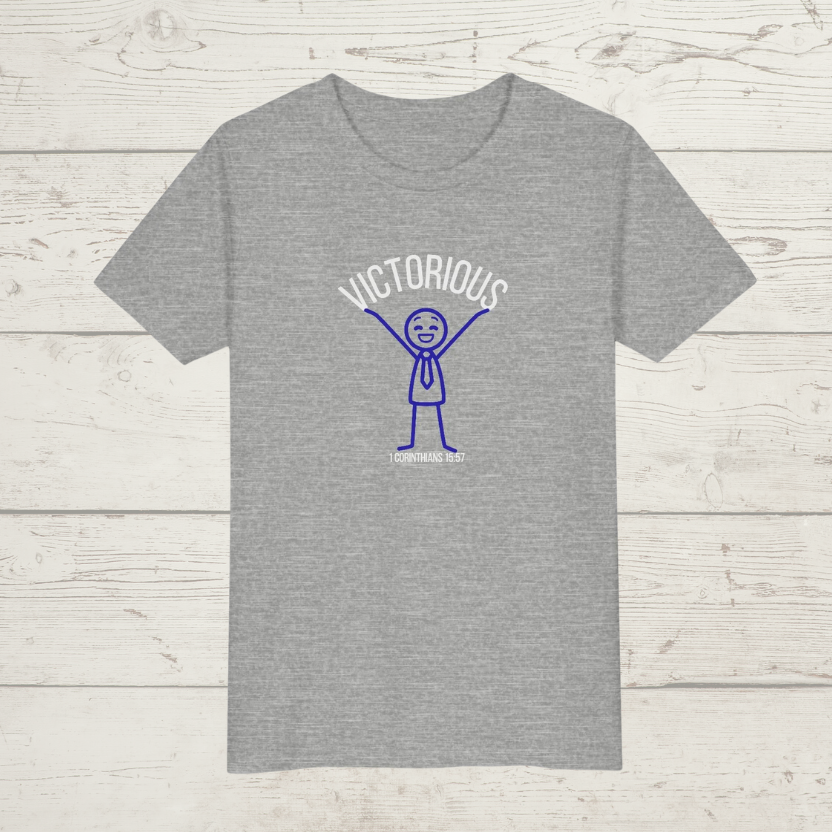 Gray t-shirt with a graphic design "Victorious' on a wooden surface