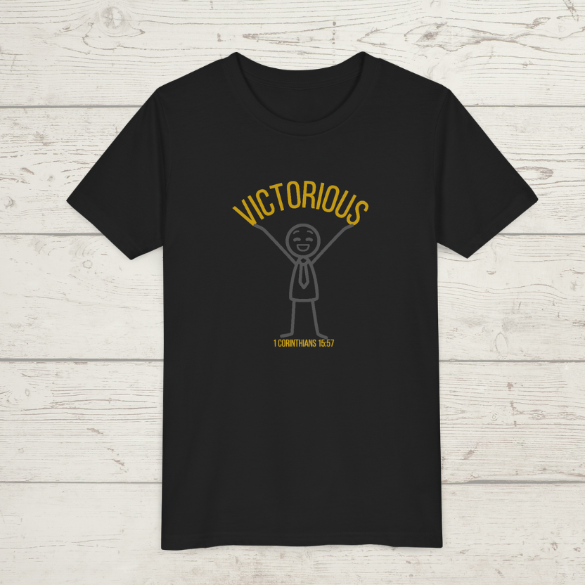 Black t-shirt with yellow 'Victorious' graphic and text on a wooden surface