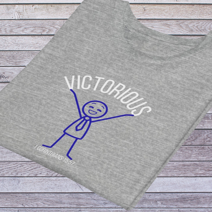 Gray t-shirt with 'Victorious' design on a wooden surface