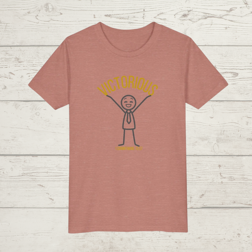 Mauve Pink t-shirt with a graphic design 'Victorious' on a wooden surface