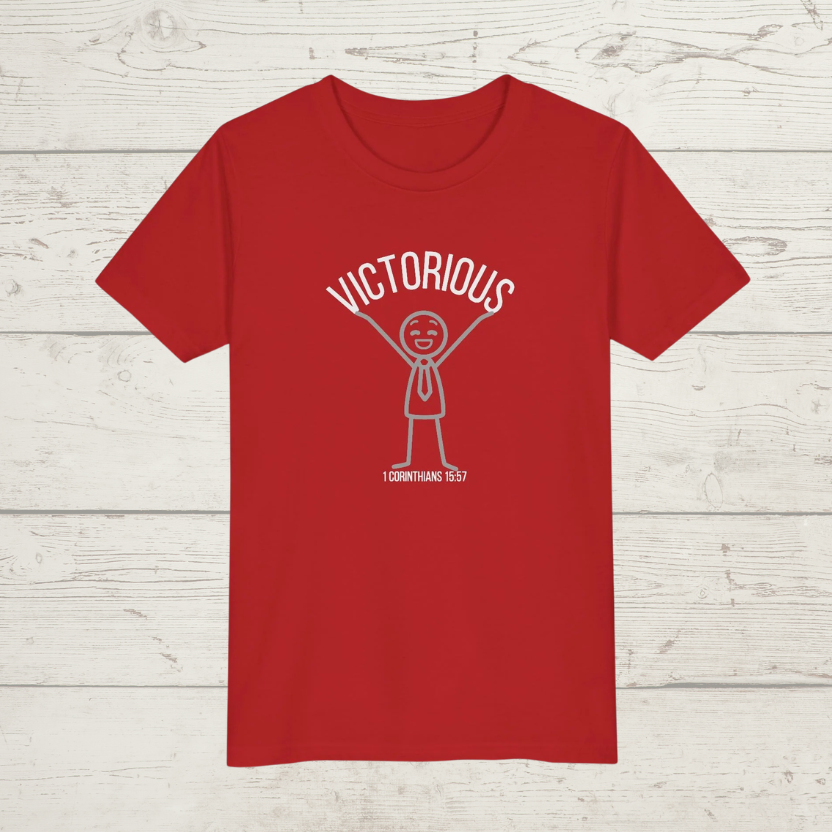 Red t-shirt with 'Victorious' graphic design on a wooden surface