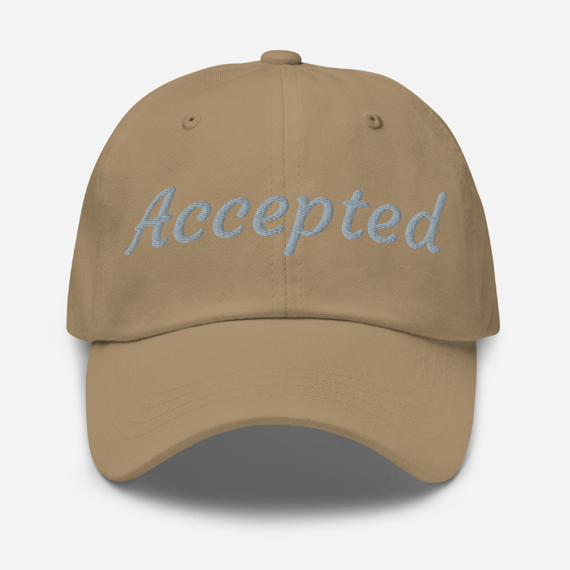 Brown cap with 'Accepted' embroidered on it against a white background
