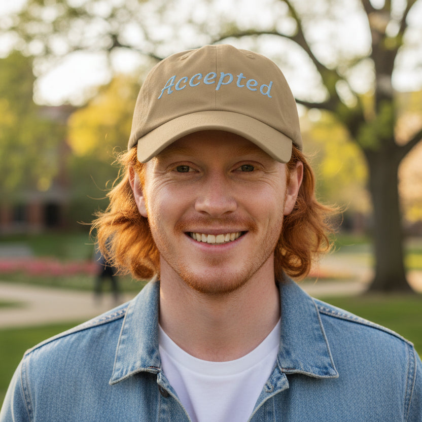 Khaki Brown cap with 'Accepted' embroidered on it, sun shining