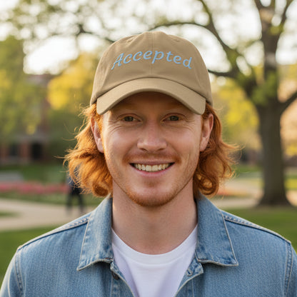 Khaki Brown cap with 'Accepted' embroidered on it, sun shining