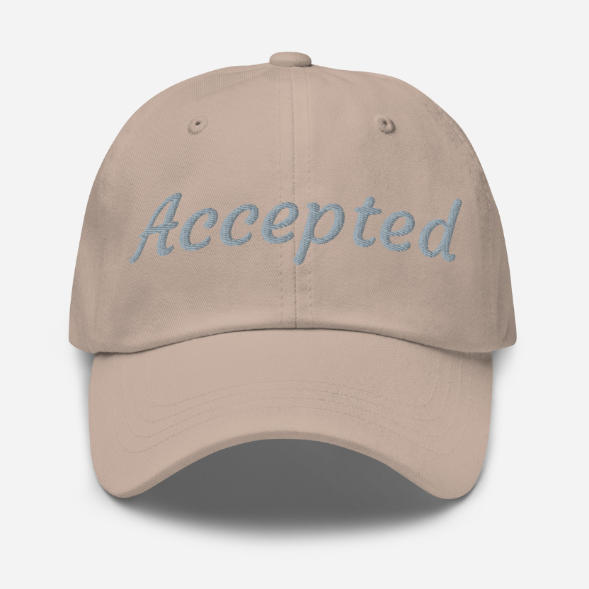Beige cap with 'Accepted' embroidered on it against a white background
