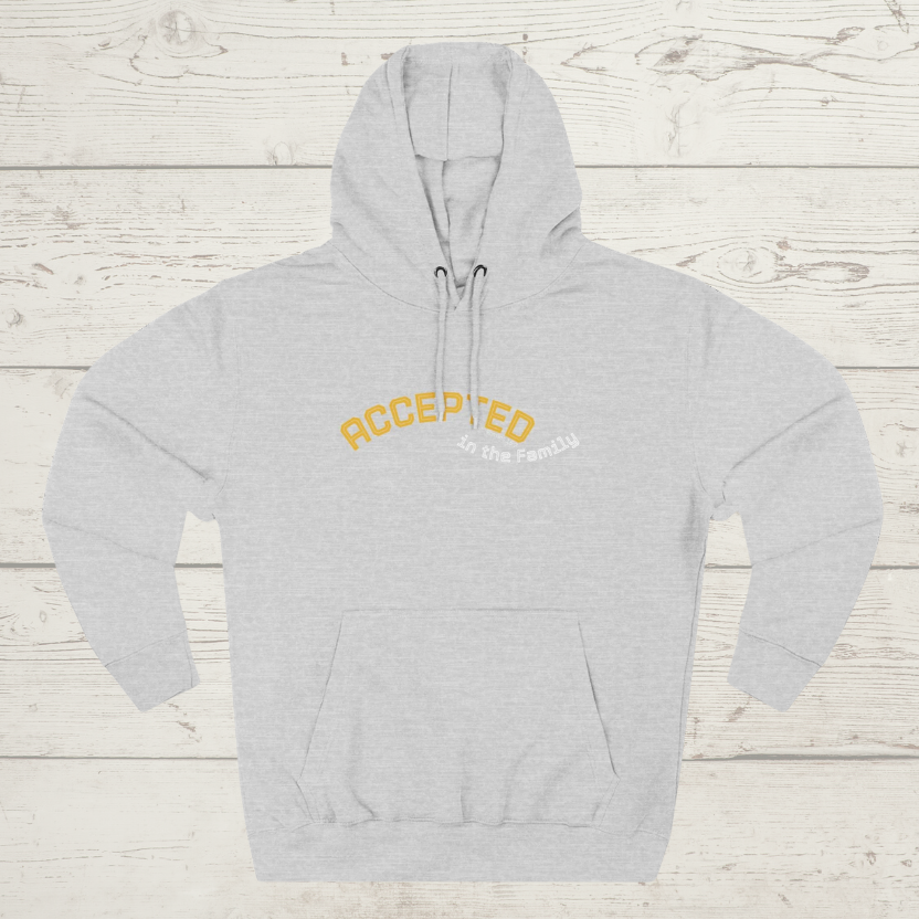 Grey hoodie with 'ACCEPTED' text on a wooden surface