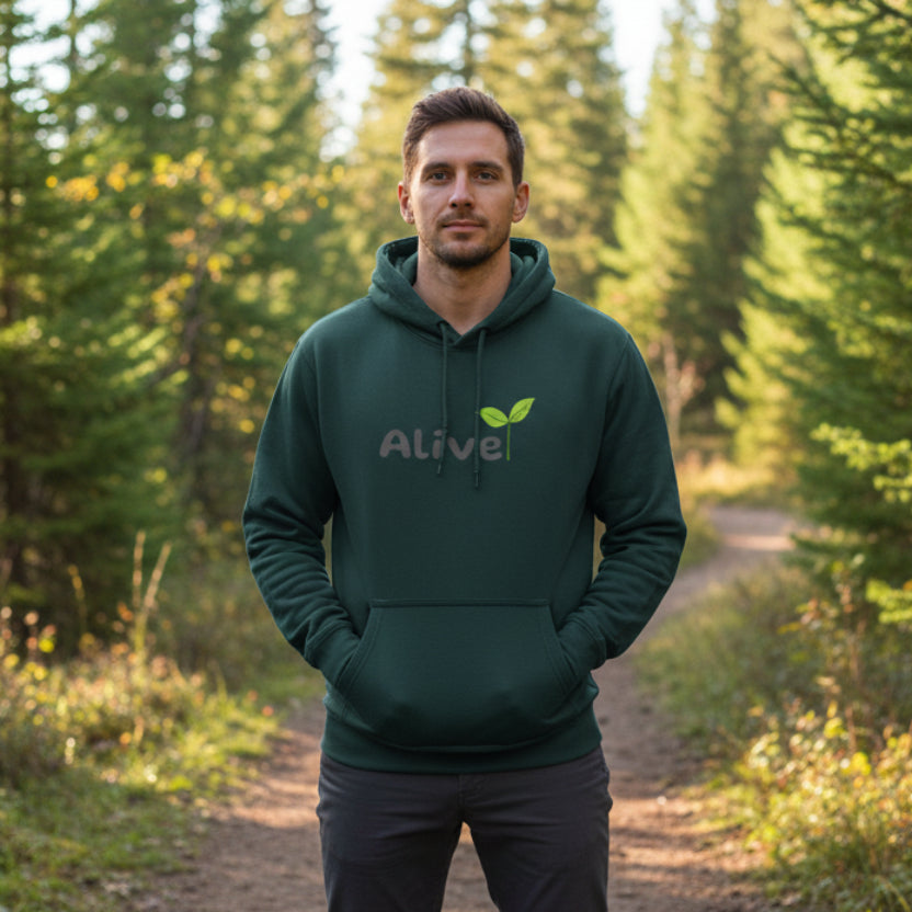 Green hoodie with 'Alive' logo and plant leaf on hiking trail