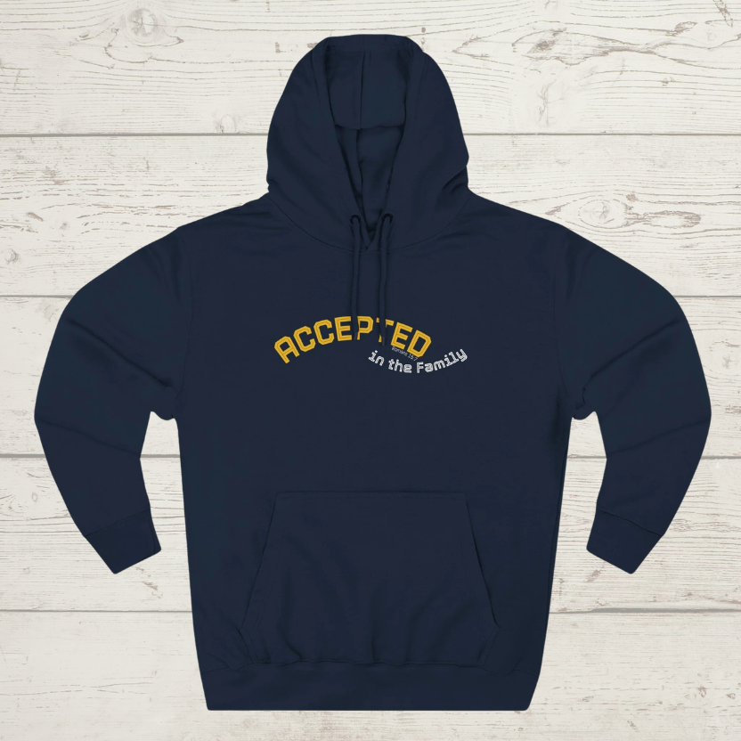Navy blue hoodie with 'ACCEPTED in the Family' text on a light wooden surface