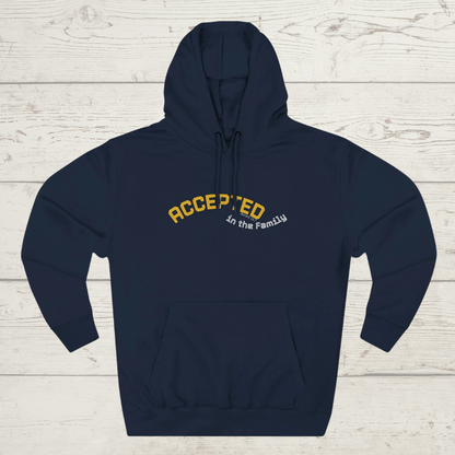 Navy blue hoodie with 'ACCEPTED in the Family' text on a light wooden surface