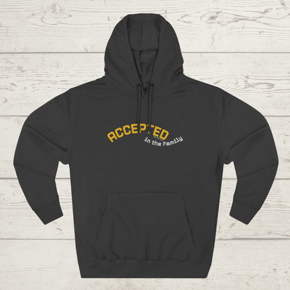 Charcoal heather hoodie with 'ACCEPTED in the Family' text on a light wooden background