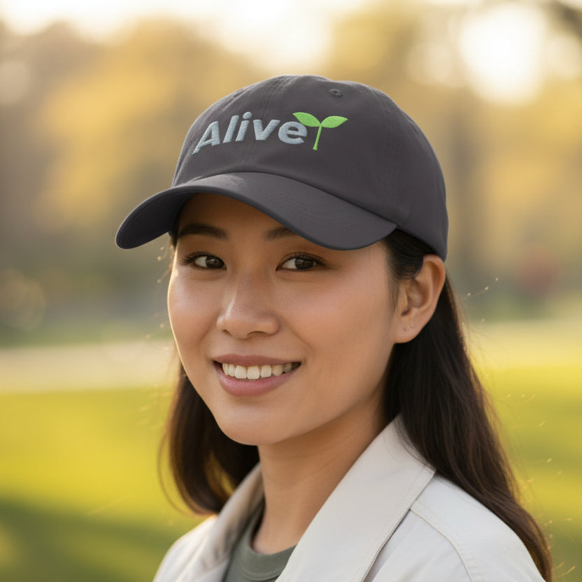 Black cap with 'Alive' text and green leaf design