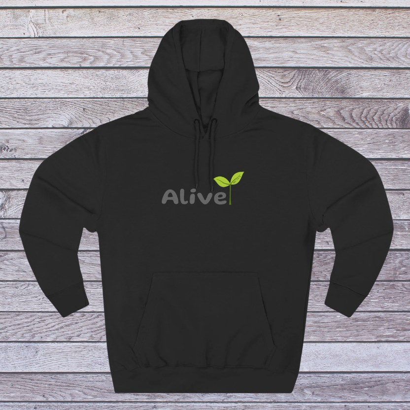 Black hoodie with 'Alive' logo on a wooden surface