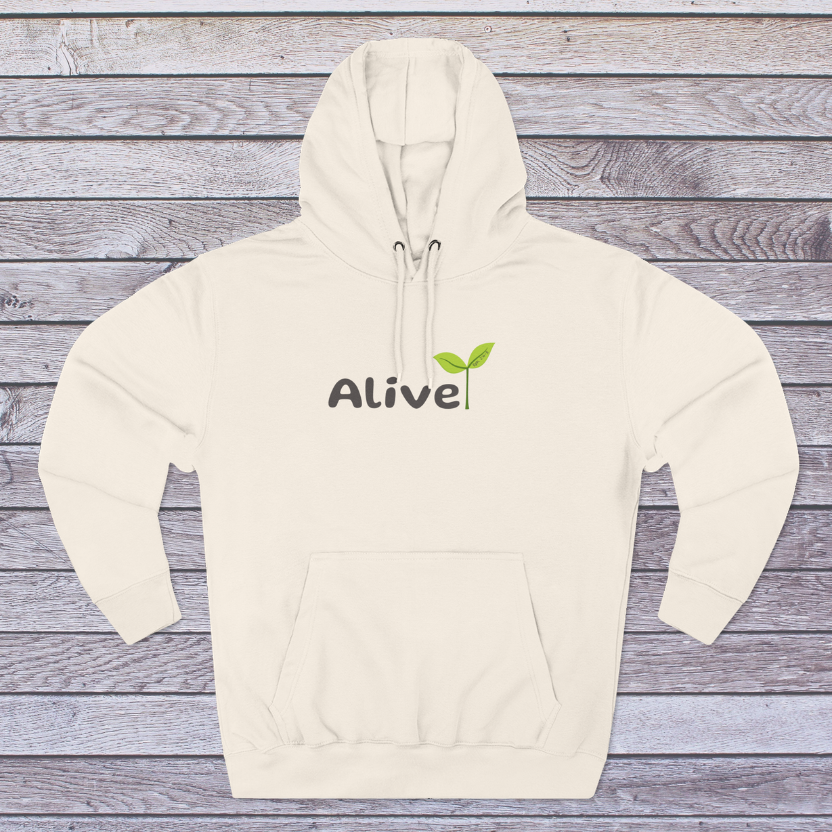 Sandshell Beige hoodie with 'Alive' logo on a wooden surface