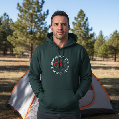 Green hoodie with a 'Blessed, Identity in Christ, Ephesians 1:3' heart logo on the chest while camping