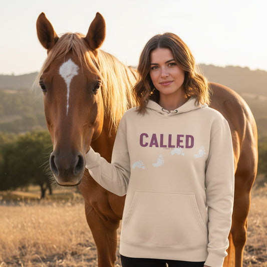 Pale Pink hoodie with 'CALLED' text in purple with white footprints, with a horse.