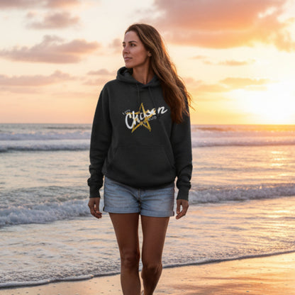Black hoodie with 'I am Chosen' logo, walking on the beach at sunset