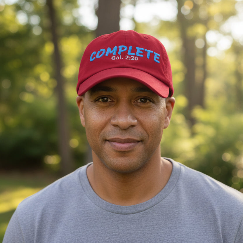 Red cap with blue and white text outside among the trees