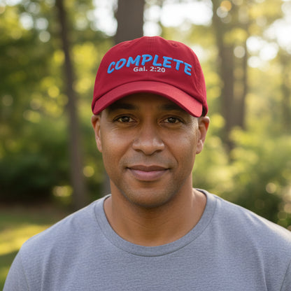 Red cap with blue and white text outside among the trees