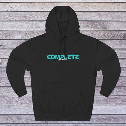 Black hoodie with teal 'COMPLETE' text on a wooden surface