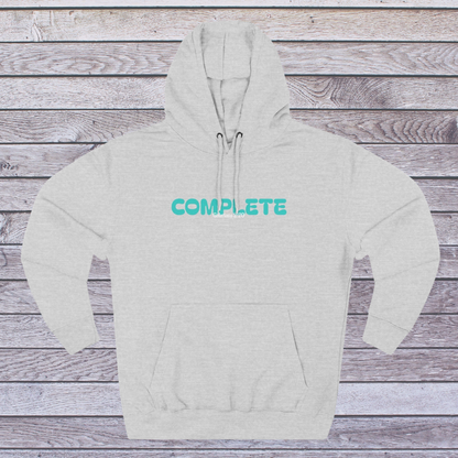 Gray hoodie with 'COMPLETE' text on a wooden surface