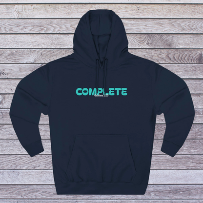 Navy hoodie with 'COMPLETE' text in teal on a wooden surface