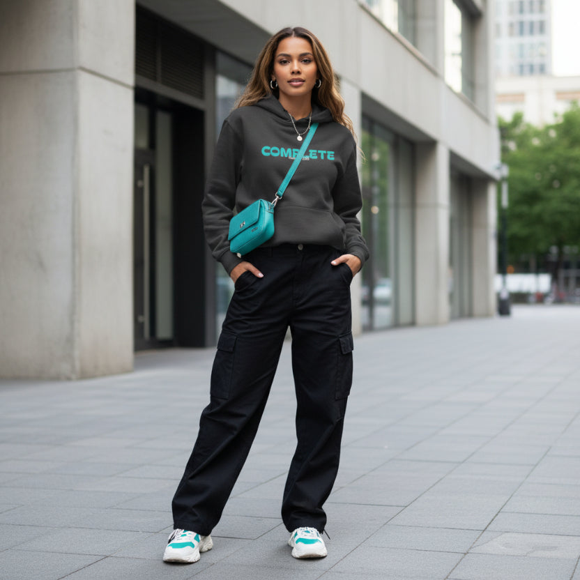 Black charcoal hoodie with teal 'COMPLETE' logo, style outfit on sidewalk