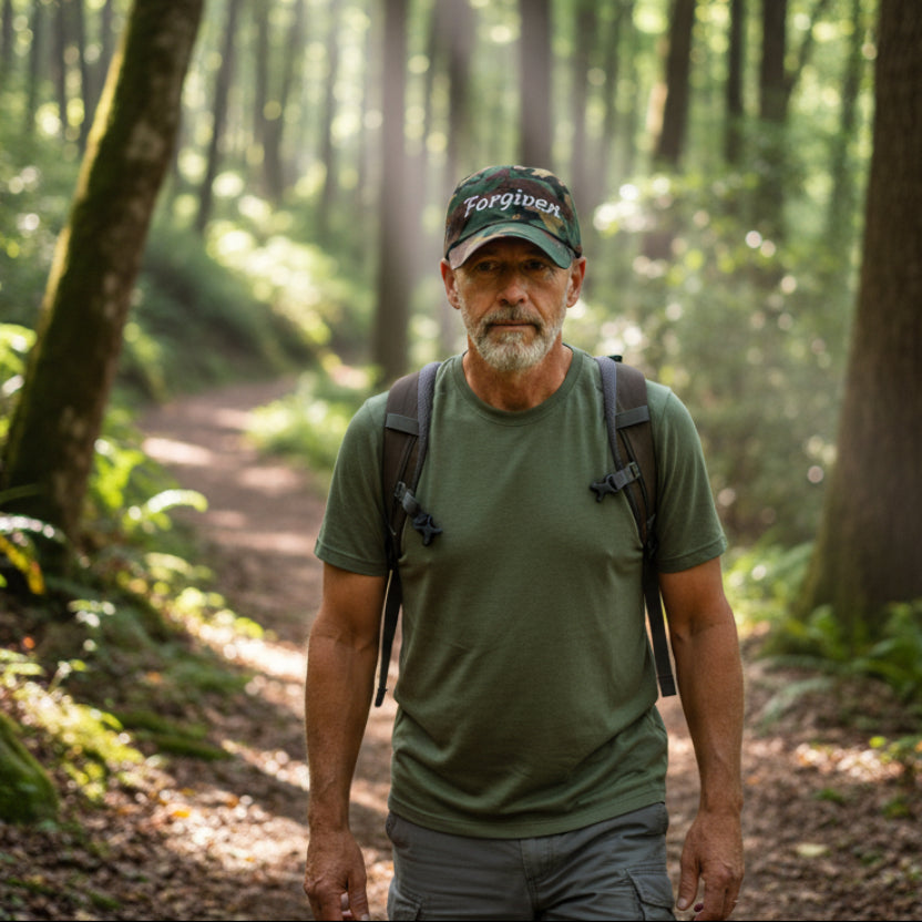 Camouflage baseball dad cap with 'Forgiven' text 50 year old hiking in the woods