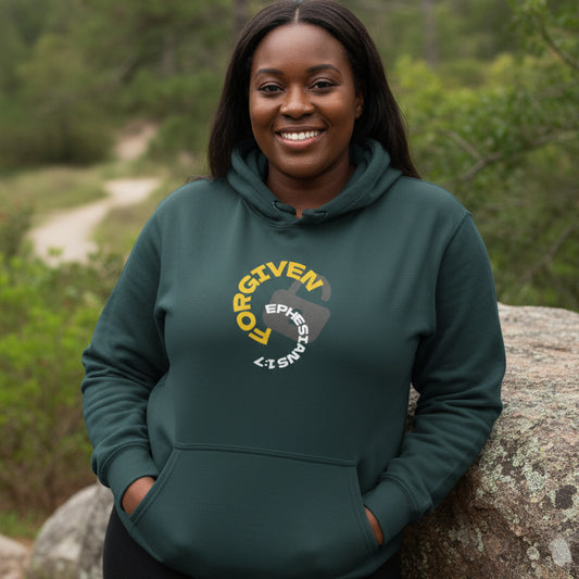 Green hoodie with 'Forgiven, Ephesians 1:7' logo, leaning against rock outside