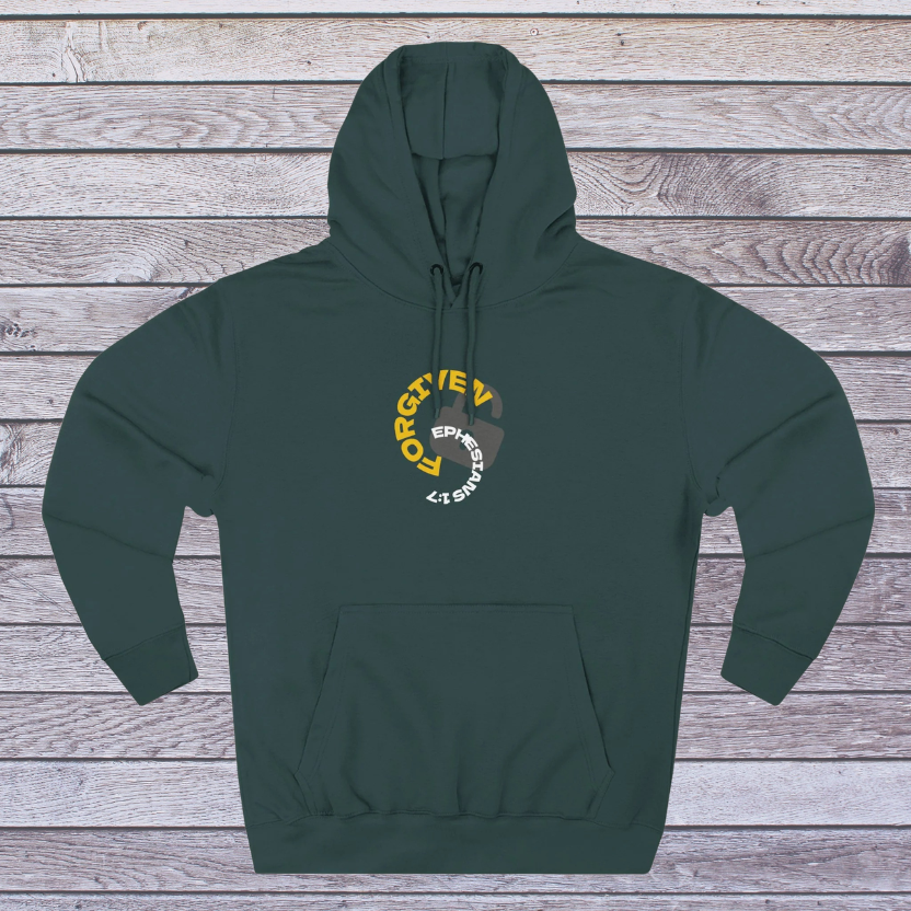 Green hoodie with a logo on a wooden surface, 'Forgiven, Ephesians 1:7' and an unlocked lock
