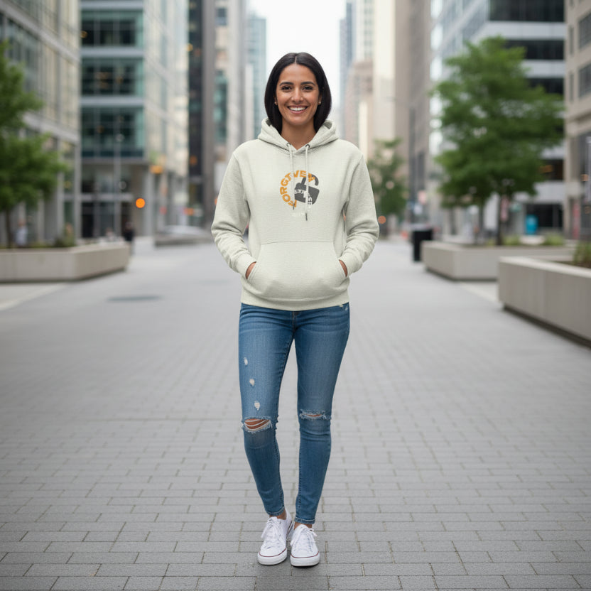 Sandshell beige hoodie with 'Forgiven, Ephesians 1:7' design in the city