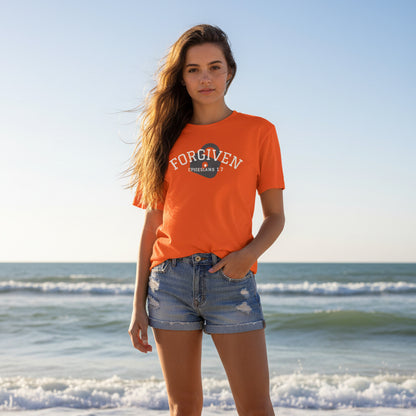 Orange t-shirt with 'FORGIVEN' text at the beach