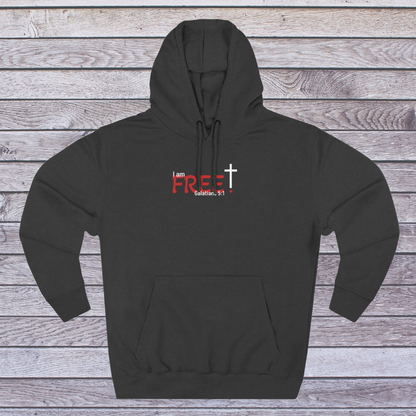 Charcoal Heather hoodie with text and a cross on a wooden background, 'I am free, Galatians'